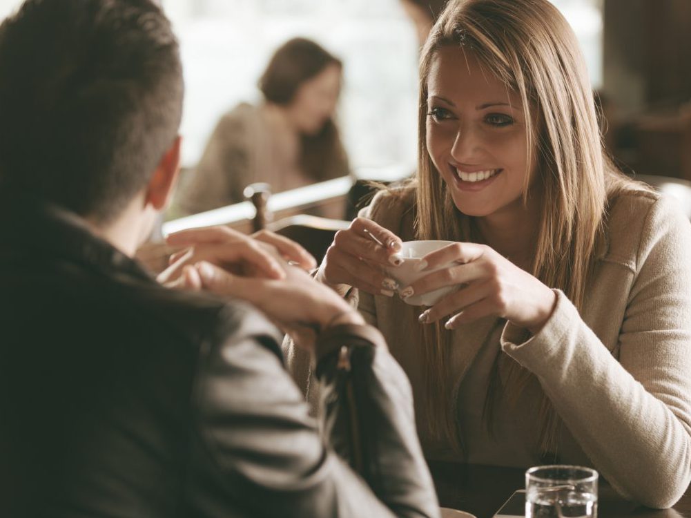 Young couple talking in restaurant