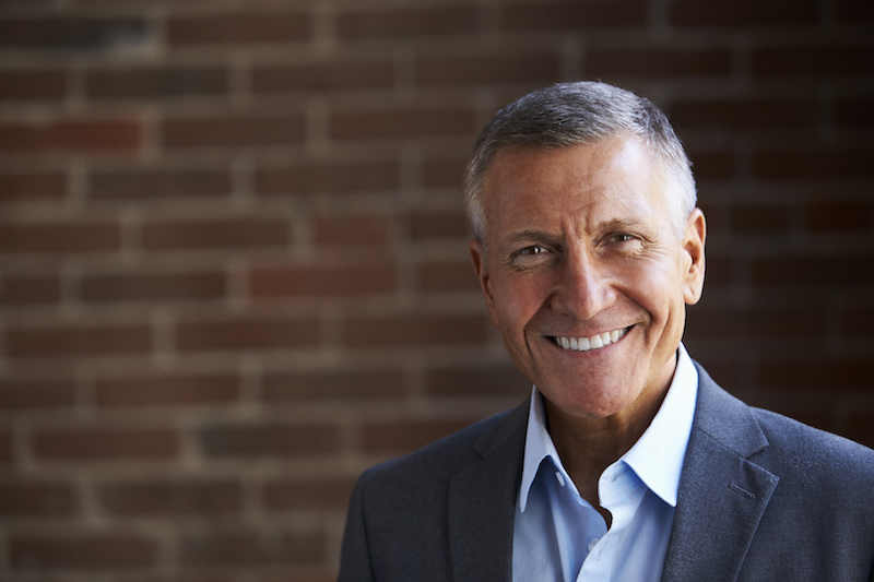Head And Shoulders Portrait Of Mature Businessman In Office