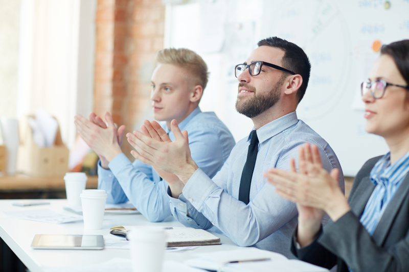 Business people clapping after training session