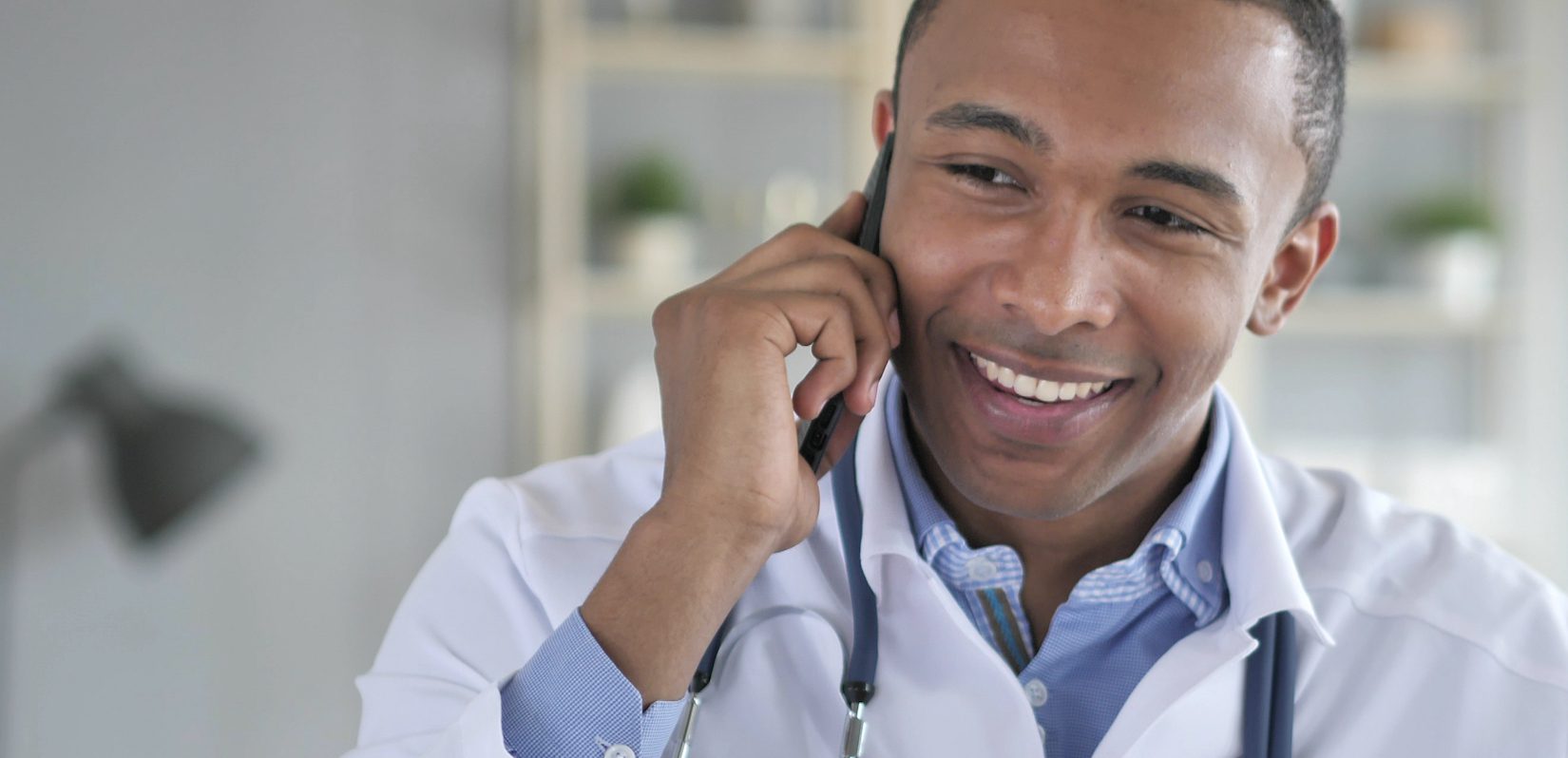 Smiling doctor on phone